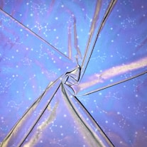 a close up of a blue umbrella with stars on it