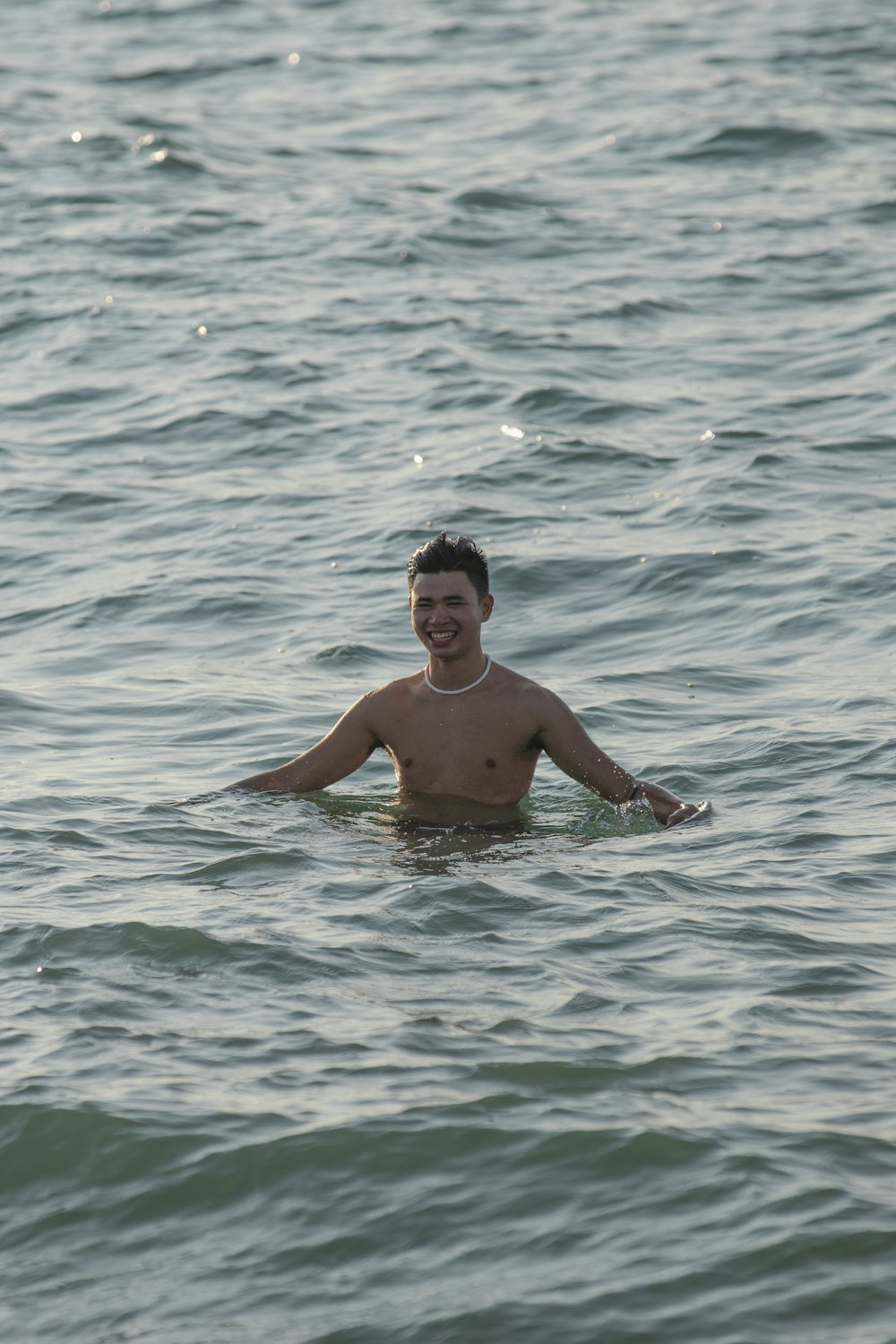 a man in a body of water with a frisbee