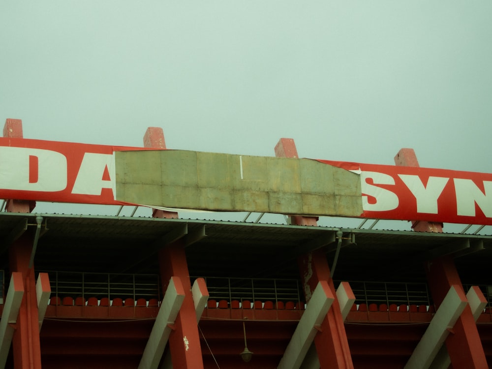 a red and white sign on top of a building