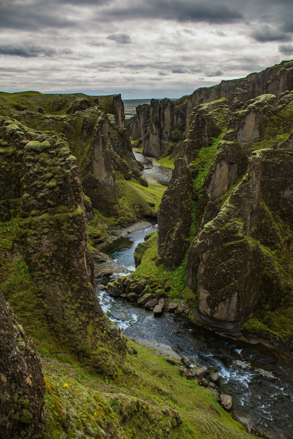 a river running through a lush green valley