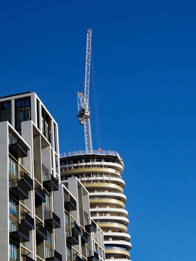 a crane is on top of a tall building