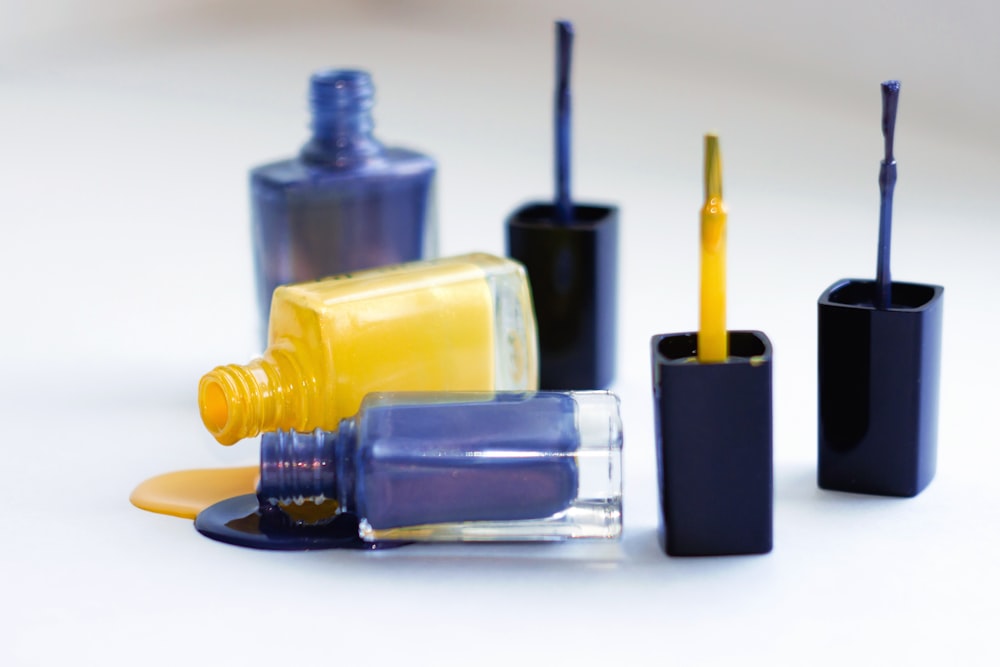 a group of different colored bottles with toothbrushes in them