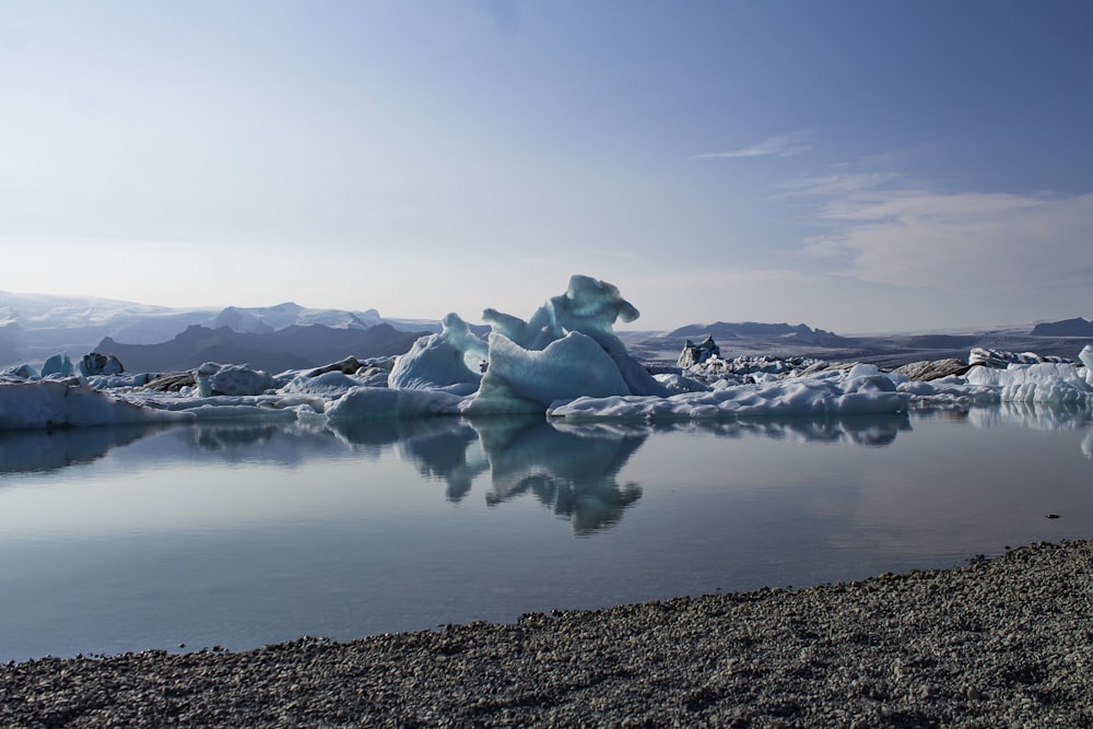 a body of water surrounded by icebergs and mountains