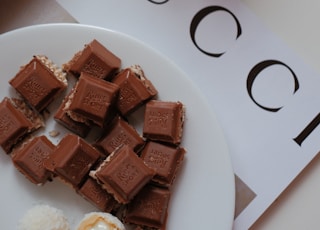 a white plate topped with pieces of chocolate