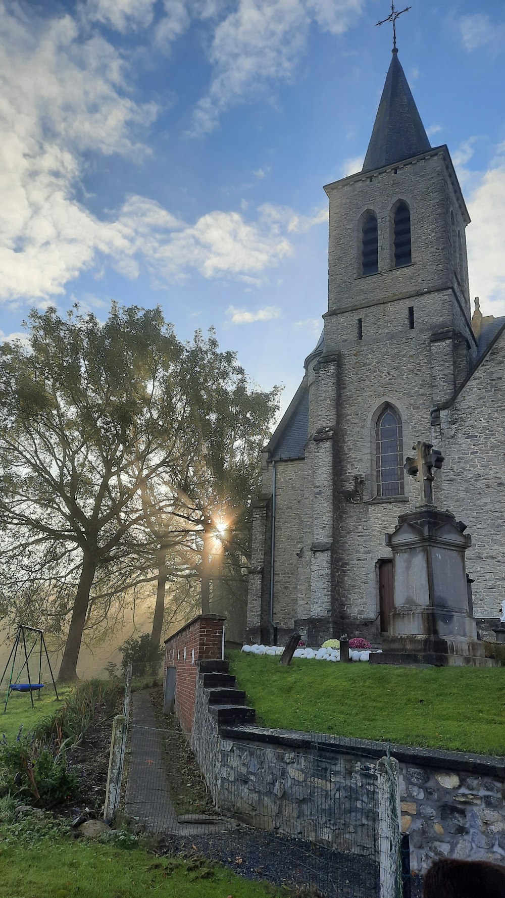 a church with a steeple and a steeple with a cross on it