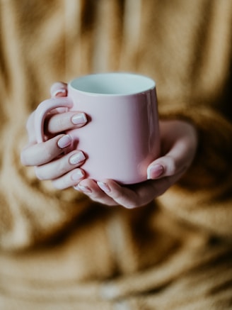 Close-up of hands holding a warm mug, symbolizing calm and relief during anxiety treatment.