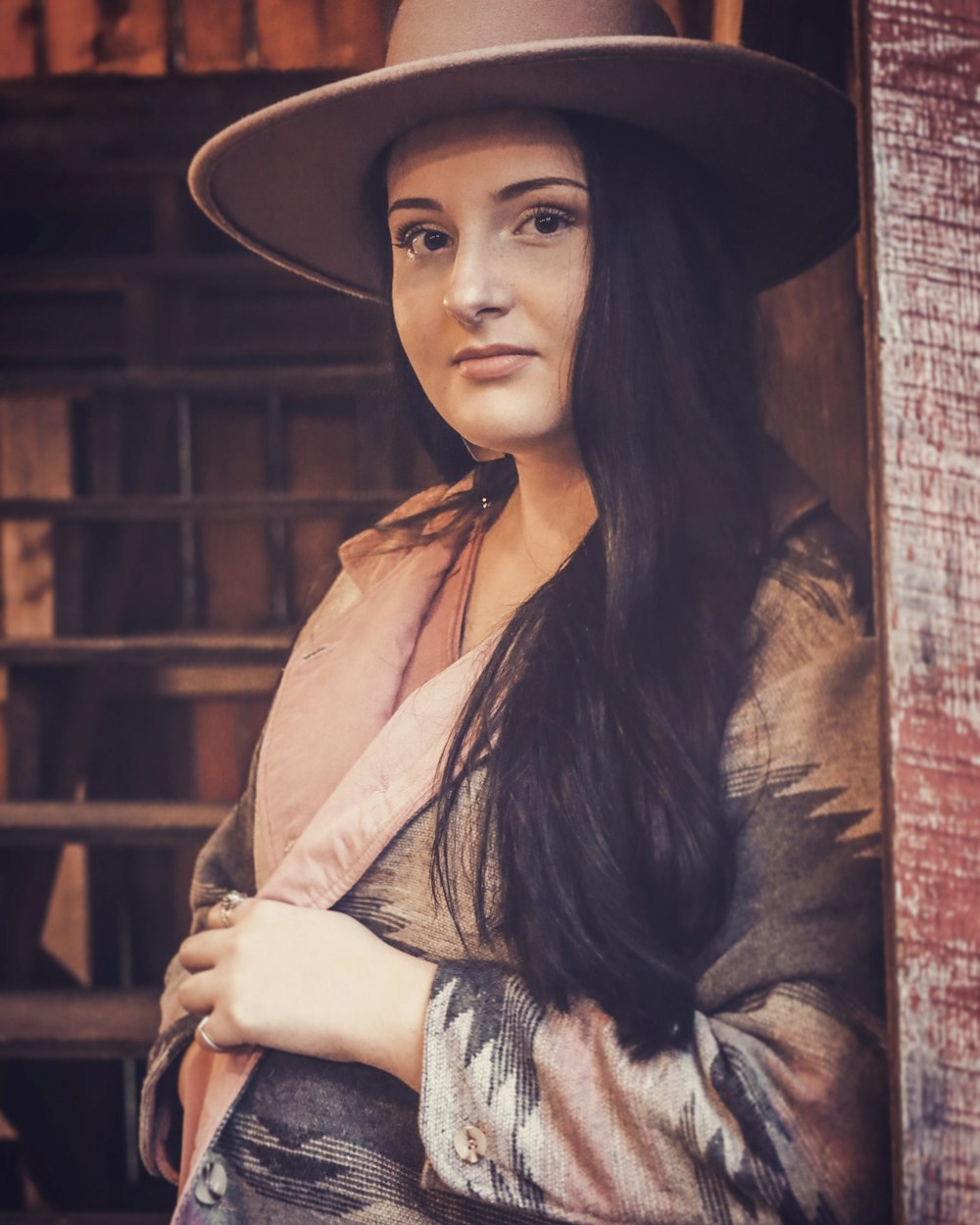 a woman with long hair wearing a hat