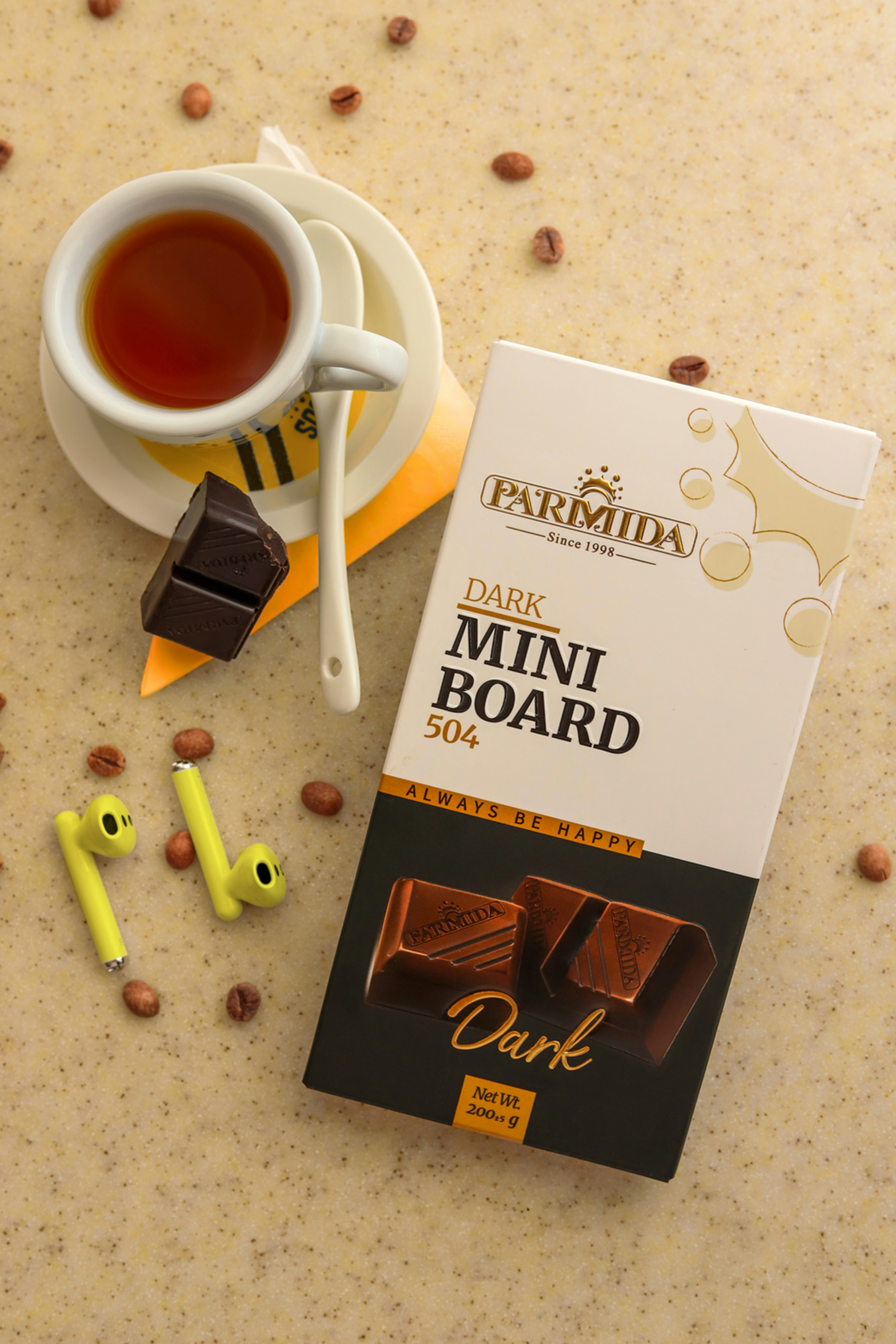 a box of dark chocolate next to a cup of coffee