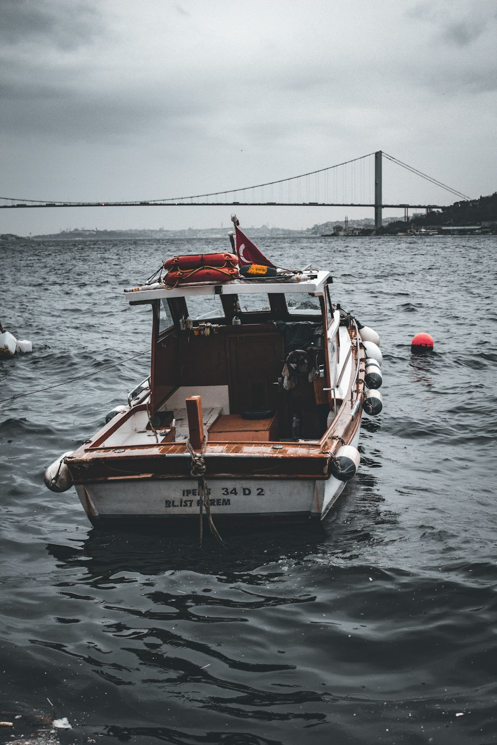 a small boat floating on top of a body of water