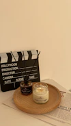 Aromatic oils and candles arranged on a wooden tray for aroma therapy