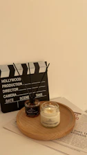 Aromatic oils and candles arranged on a wooden tray for aroma therapy