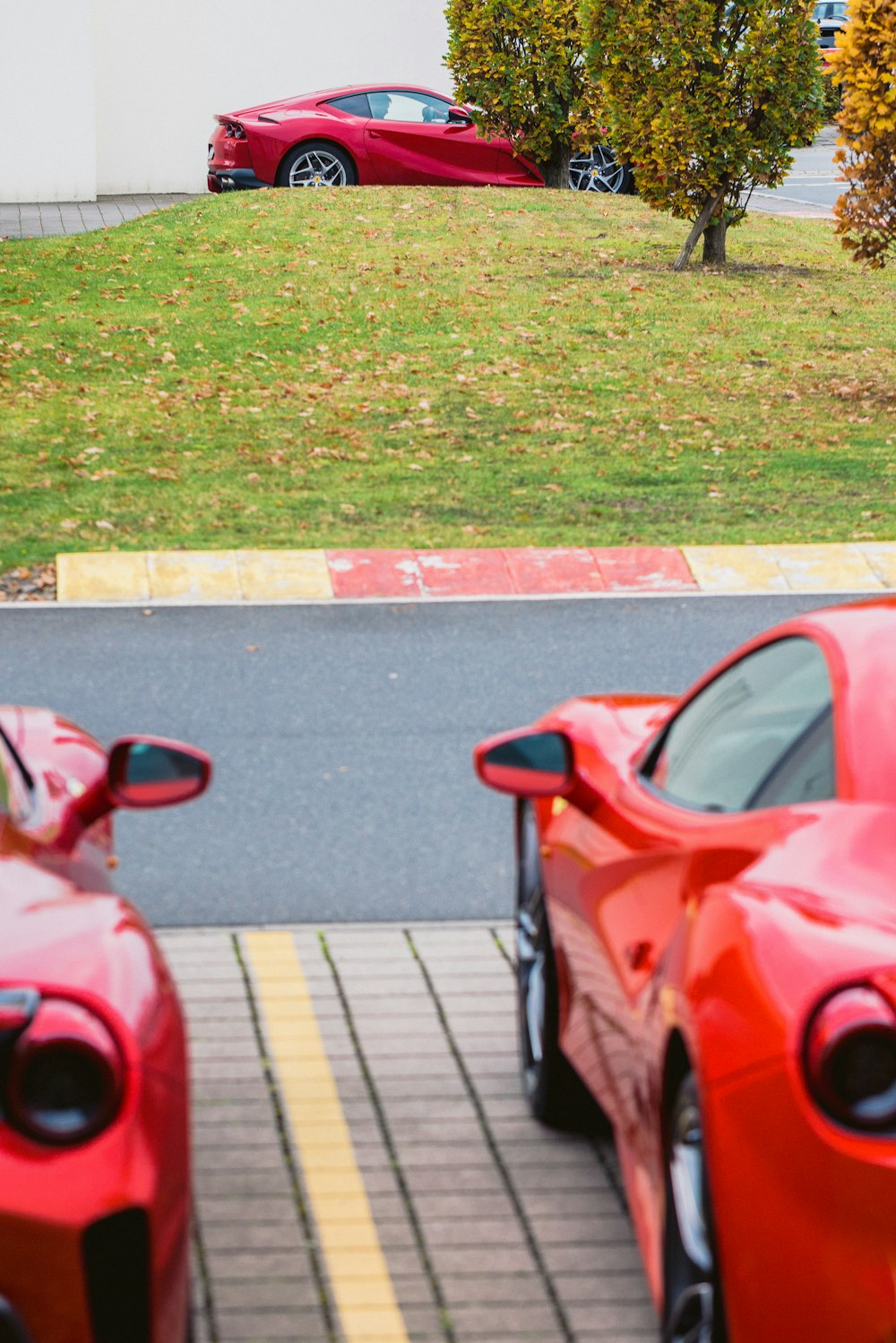 two red sports cars parked next to each other