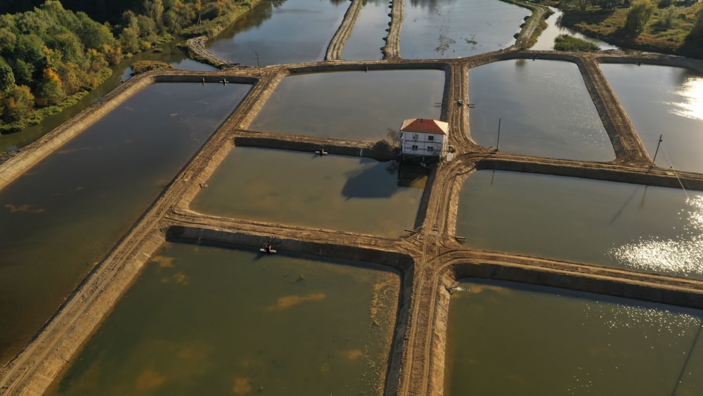 an aerial view of a house surrounded by water