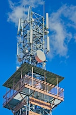 a tall tower with a satellite dish on top of it