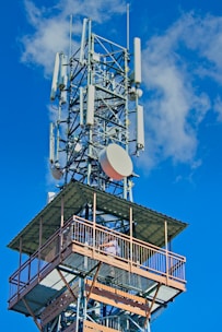a tall tower with a satellite dish on top of it