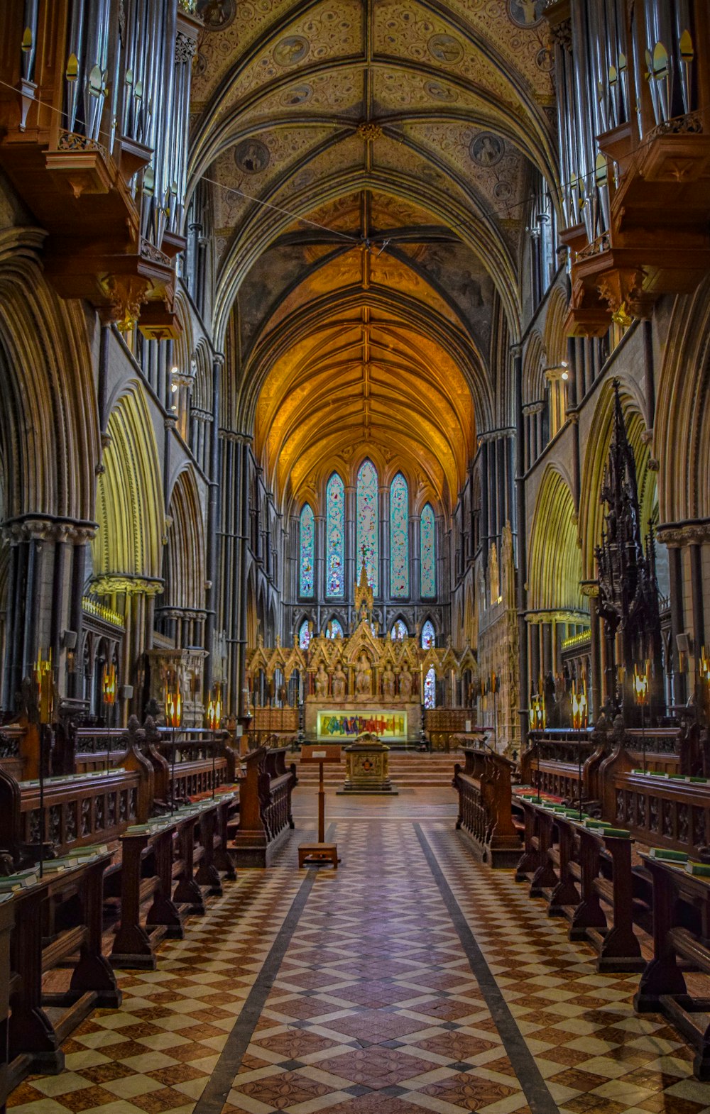 a cathedral with a checkered floor and pews