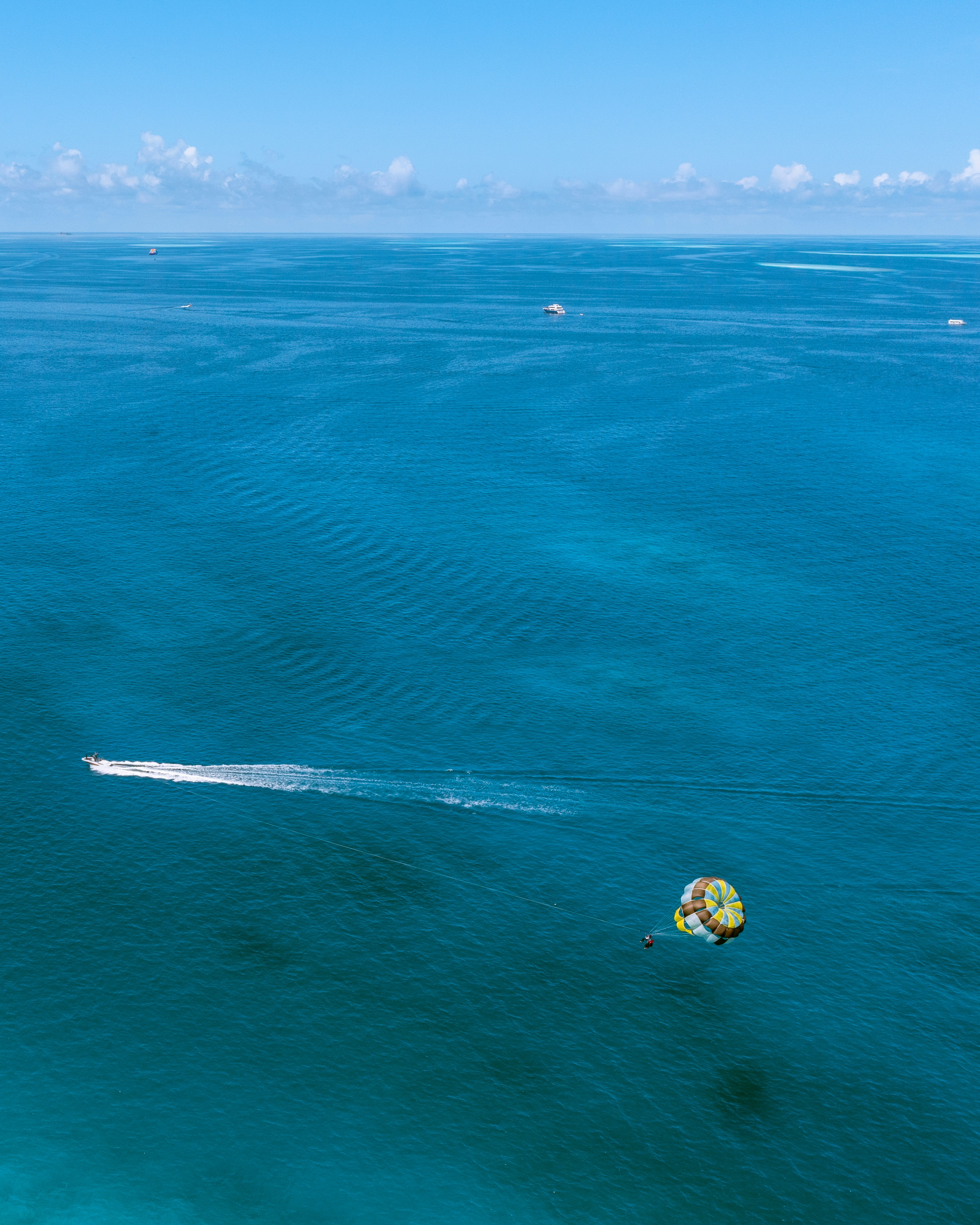 a jet ski being pulled by a boat in the ocean
