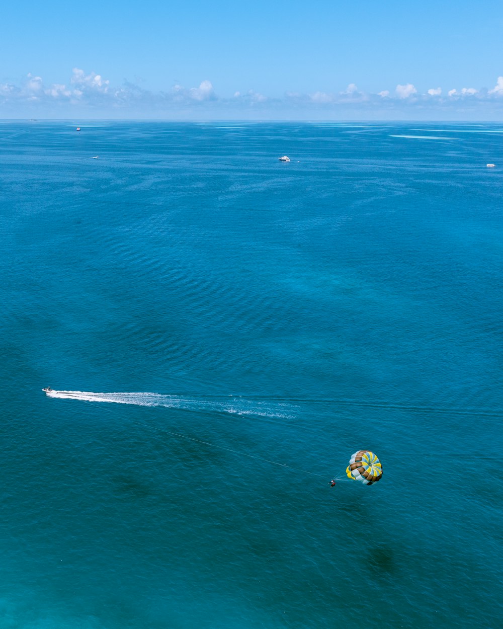 a jet ski being pulled by a boat in the ocean