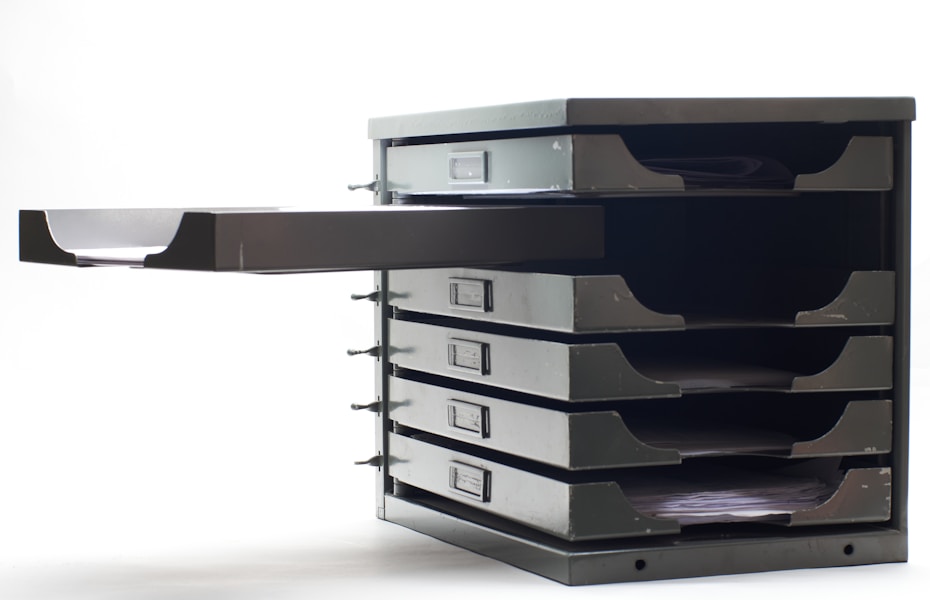A stack of filing drawers, representing a queue of exception cases waiting for a human owner