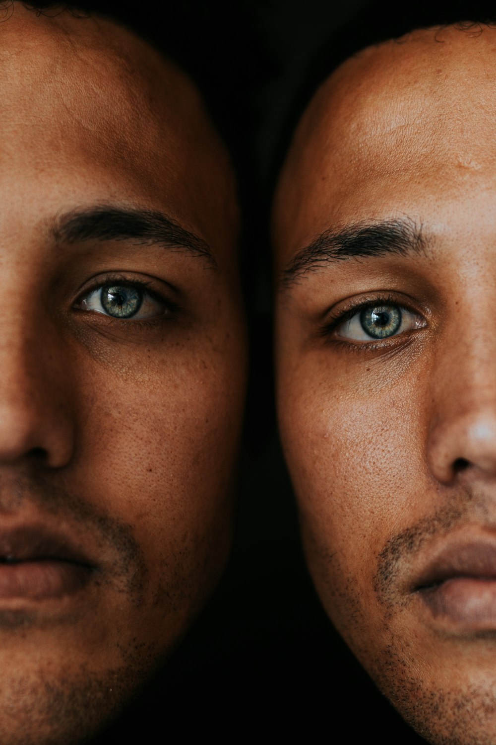 a close up of a man's face with blue eyes