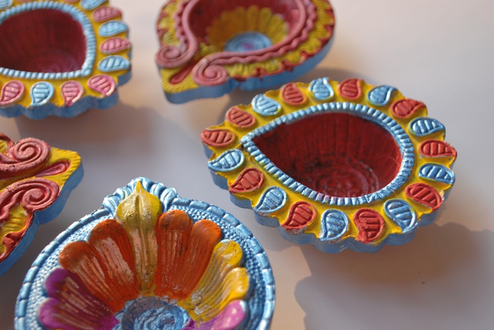 a group of four colorful bowls sitting on top of a table