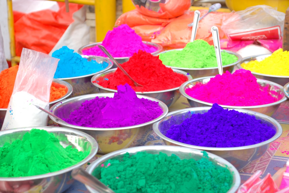 a table topped with bowls filled with different colored powder