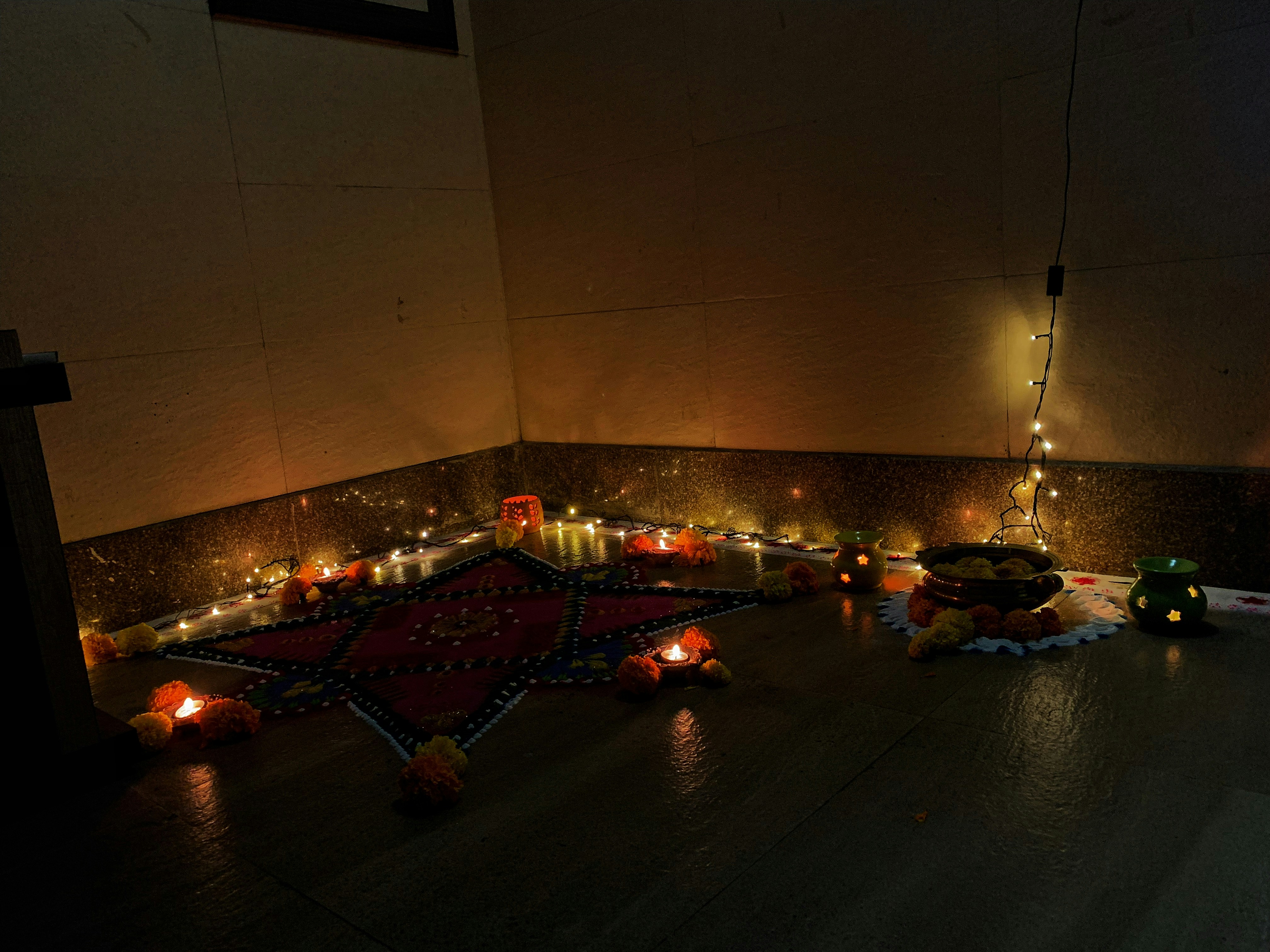 A cozy corner featuring handcrafted home decor pieces like earthen lamps and carved wooden figurines.