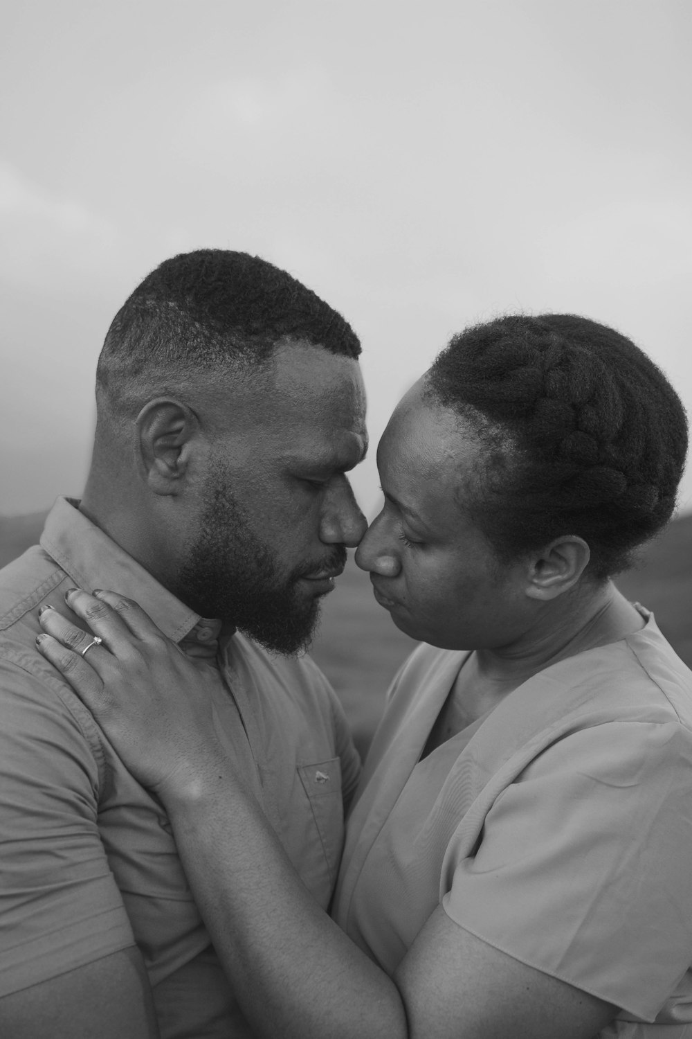 a black and white photo of a couple embracing
