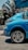 a blue car parked in front of a building