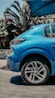 a blue car parked in front of a building