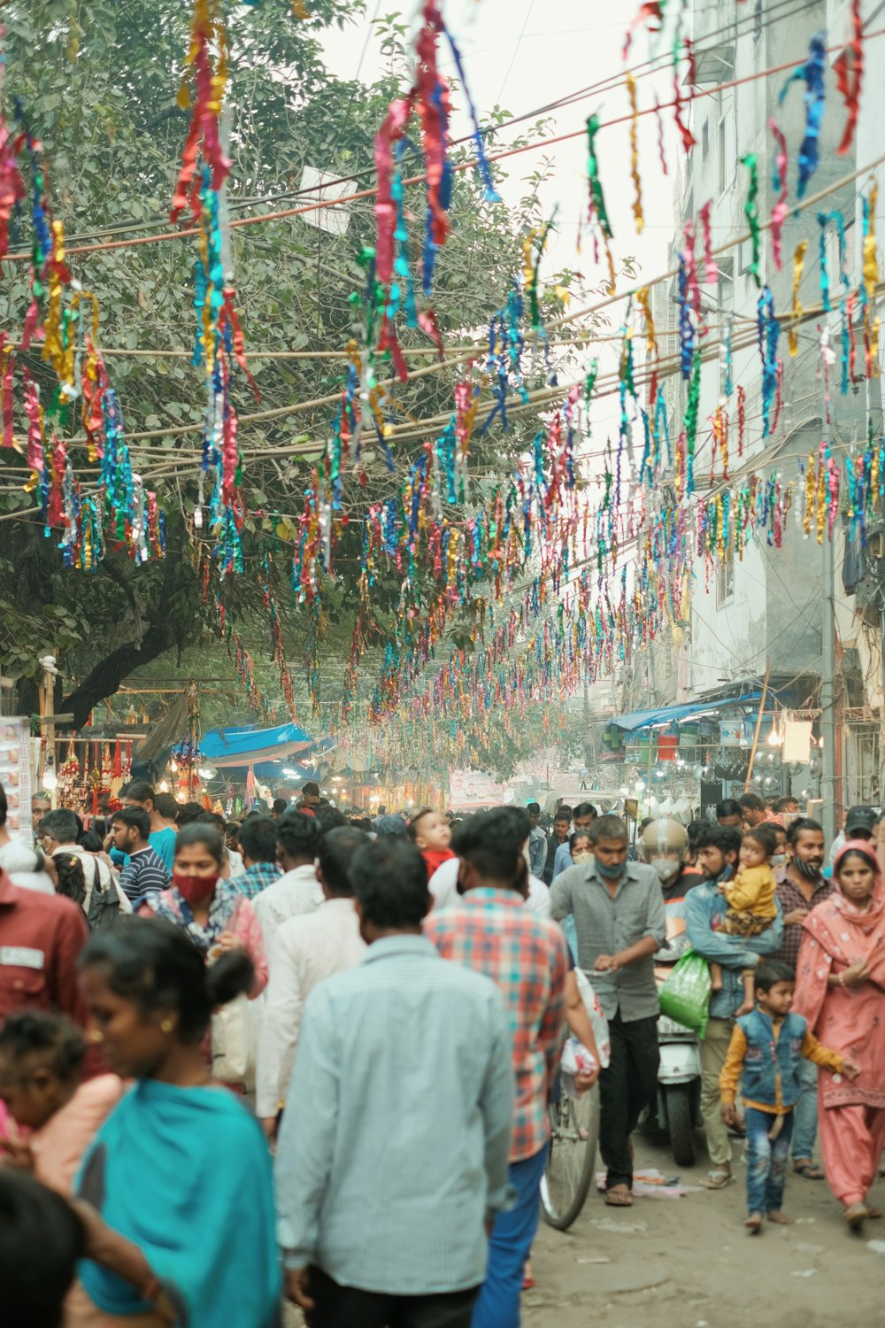 a crowd of people walking down a street