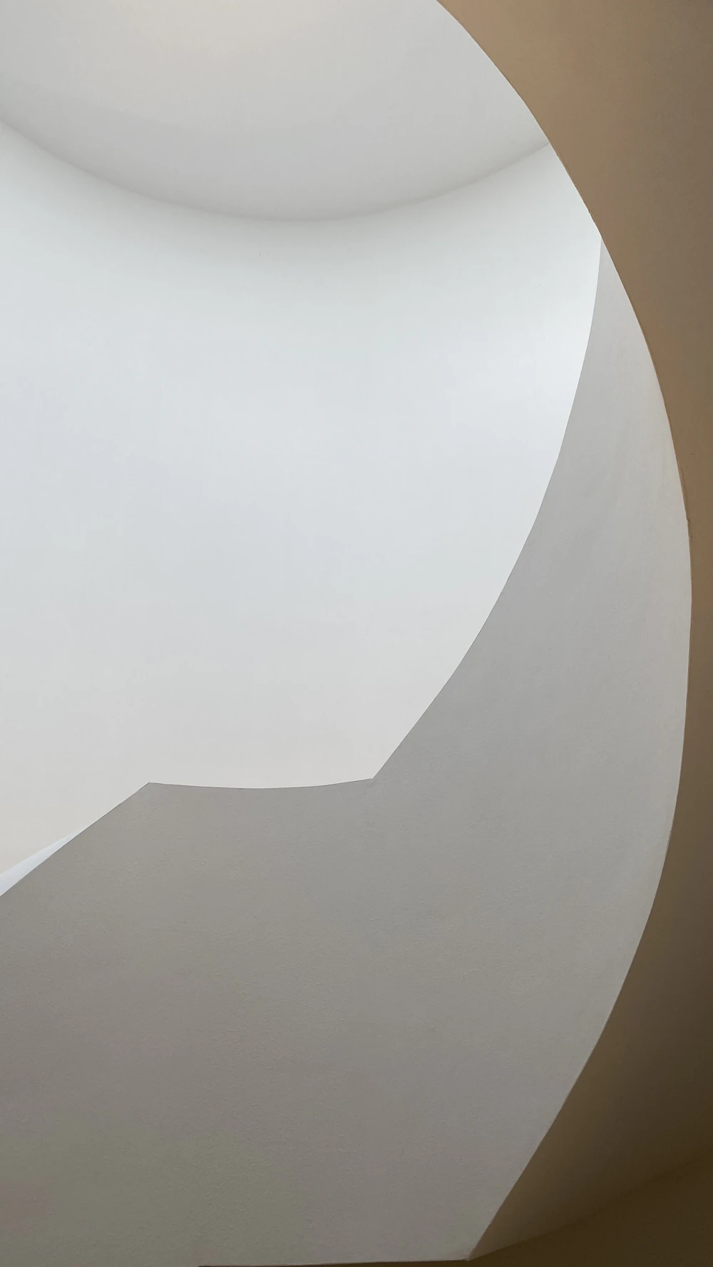 Layered plaster textures turning a stair into sculpture.