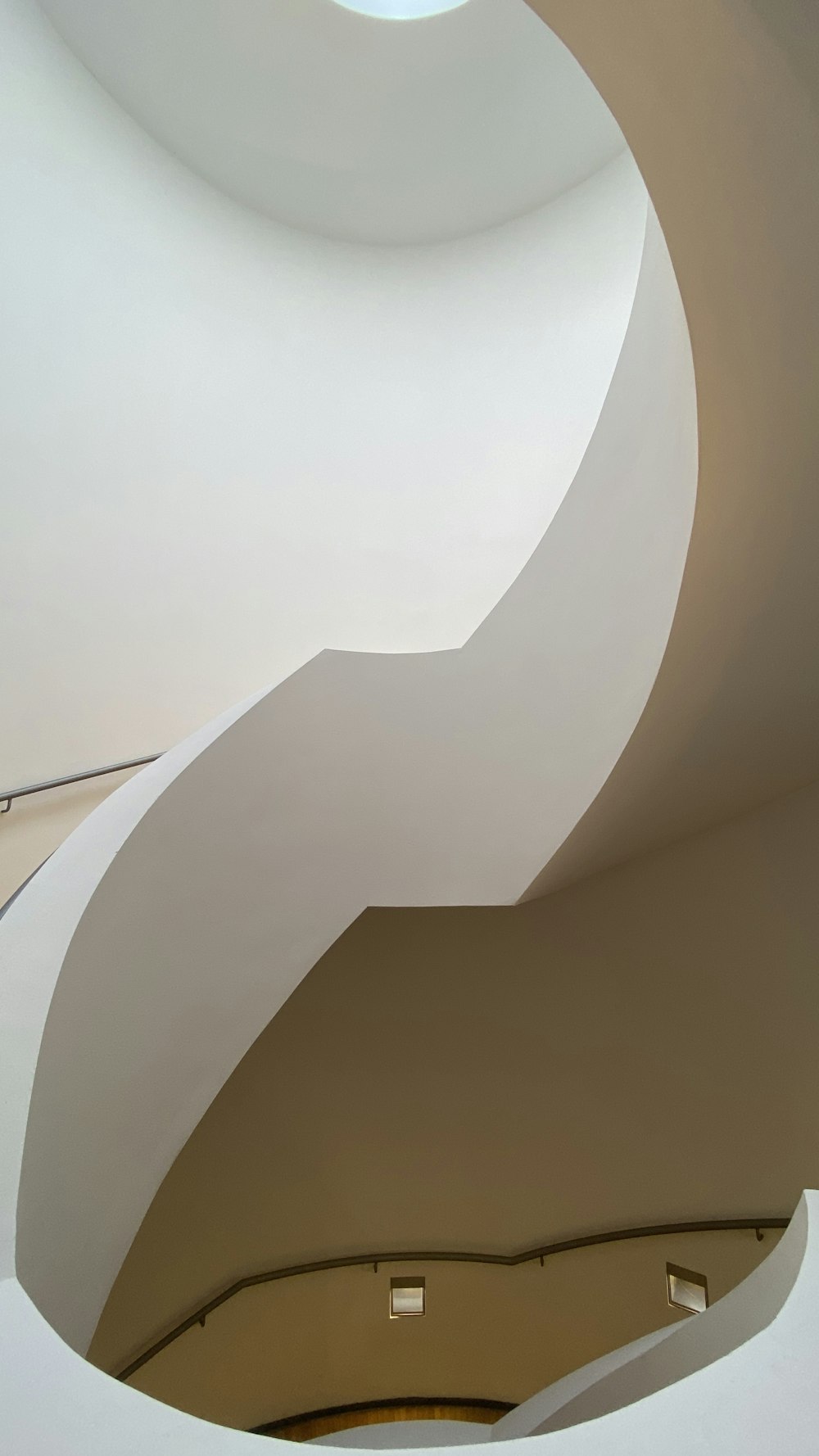 a curved ceiling with a skylight above it
