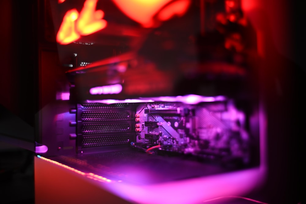 the inside of a computer with a red and purple light