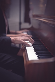 a person playing a piano with their hands