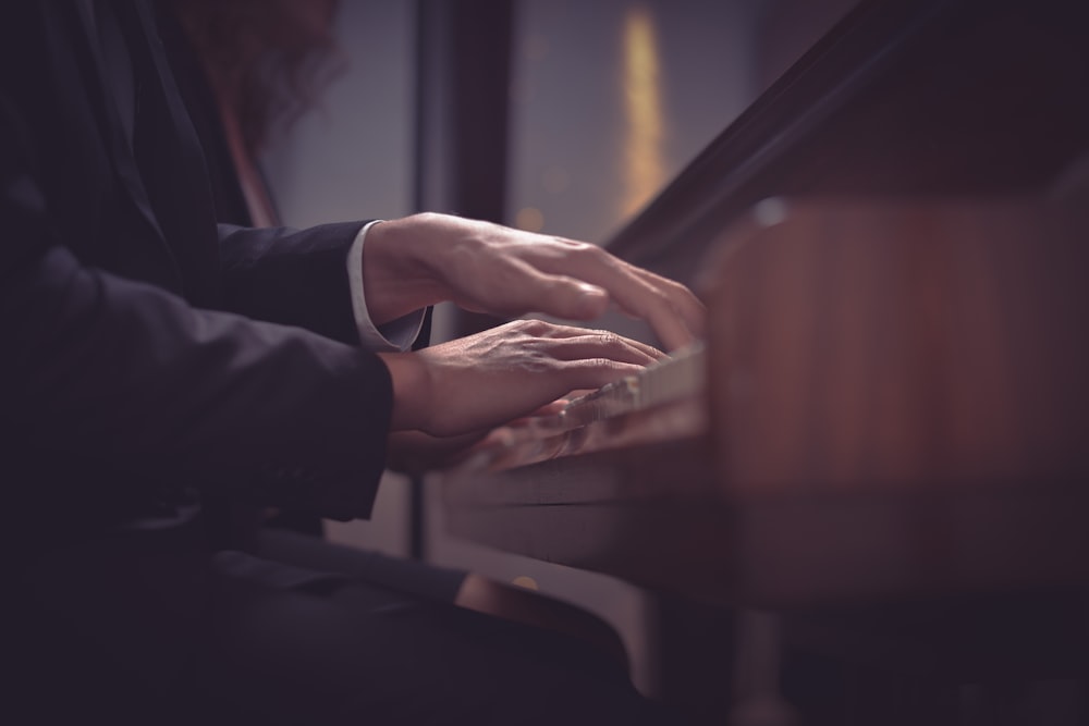 a person playing a piano in a dark room