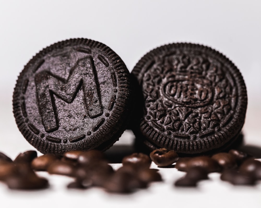 two oreos sitting on top of a pile of coffee beans