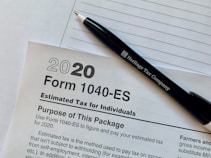 a pen sitting on top of a tax form