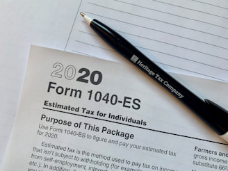 a pen sitting on top of a tax form