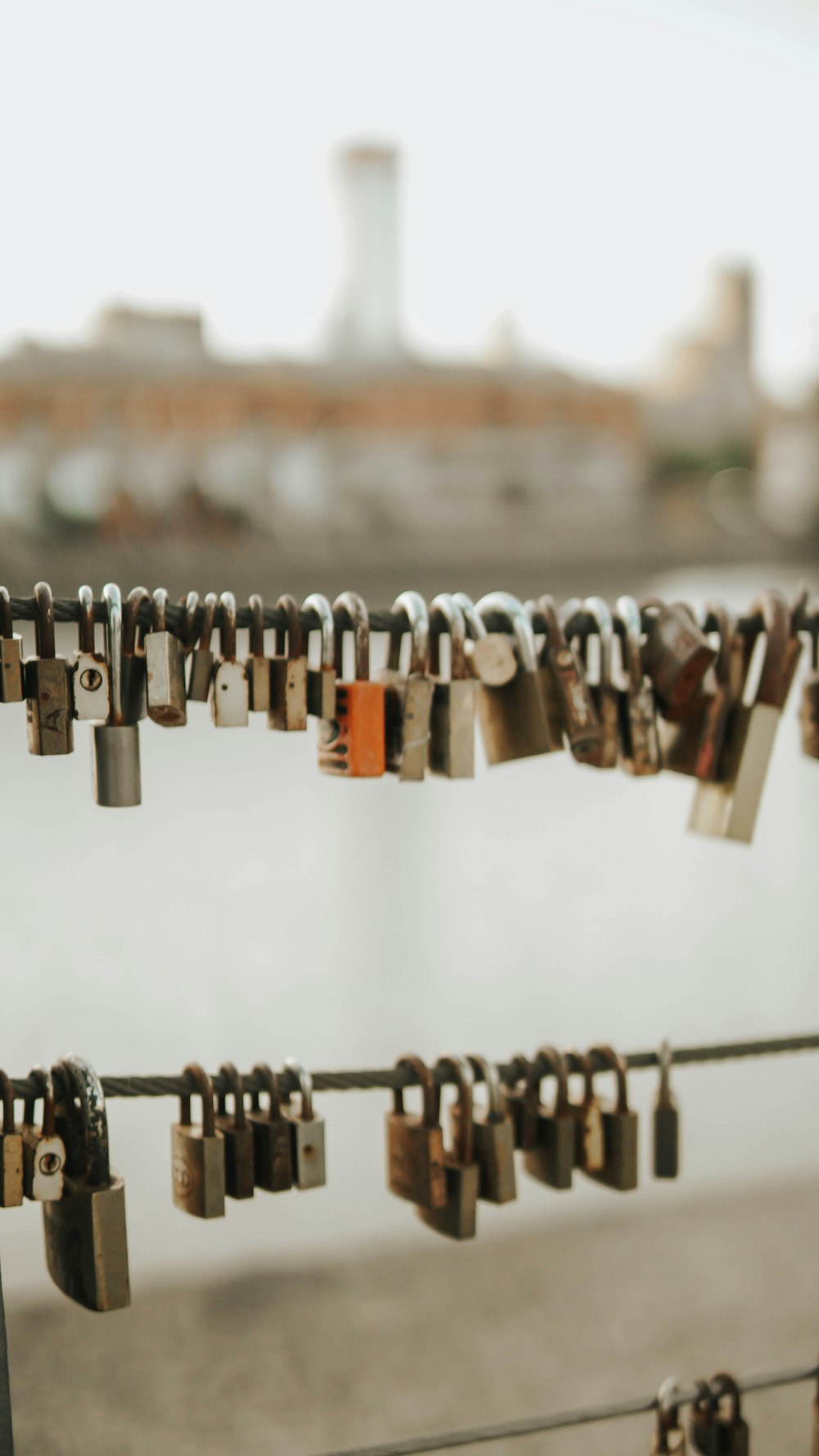 a bunch of padlocks are hanging on a line