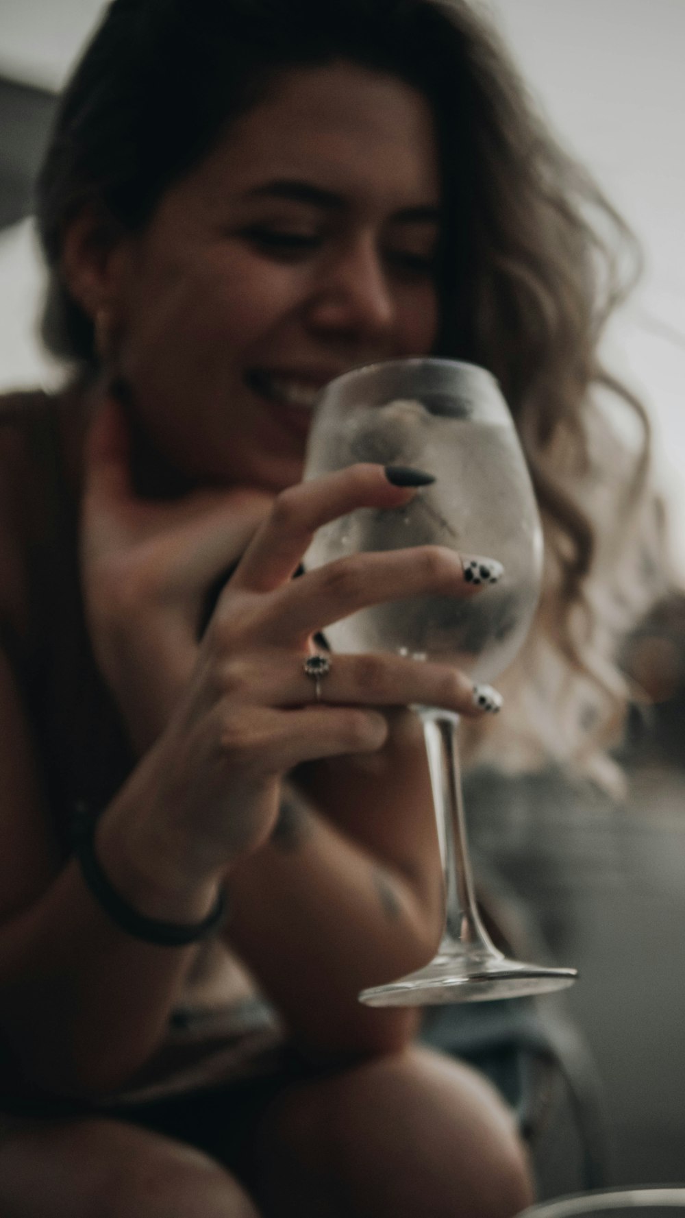 a woman holding a wine glass in her hand