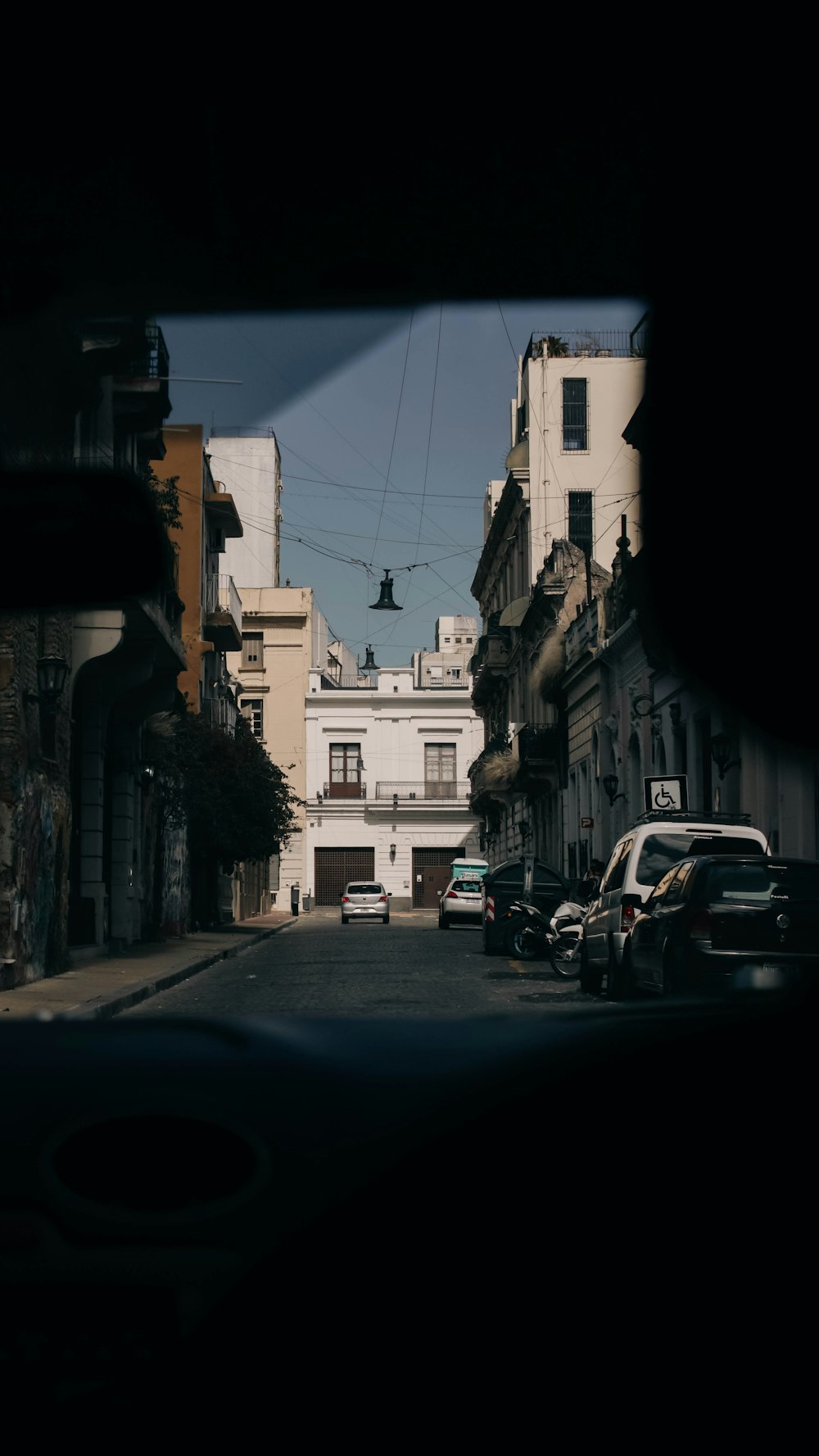 a view of a city street from inside a vehicle