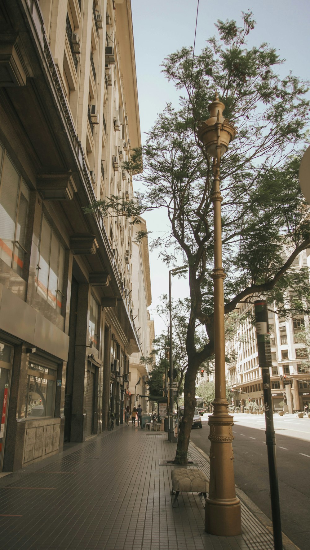 a lamp post sitting on the side of a street