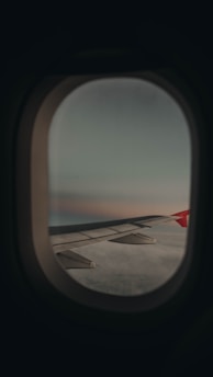 a view of the wing of an airplane through a window
