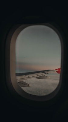 a view of the wing of an airplane through a window