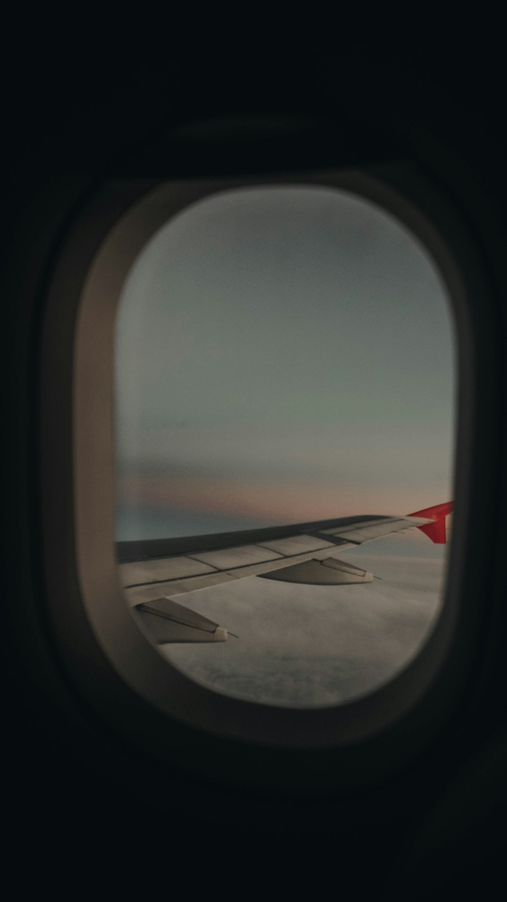 a view of the wing of an airplane through a window