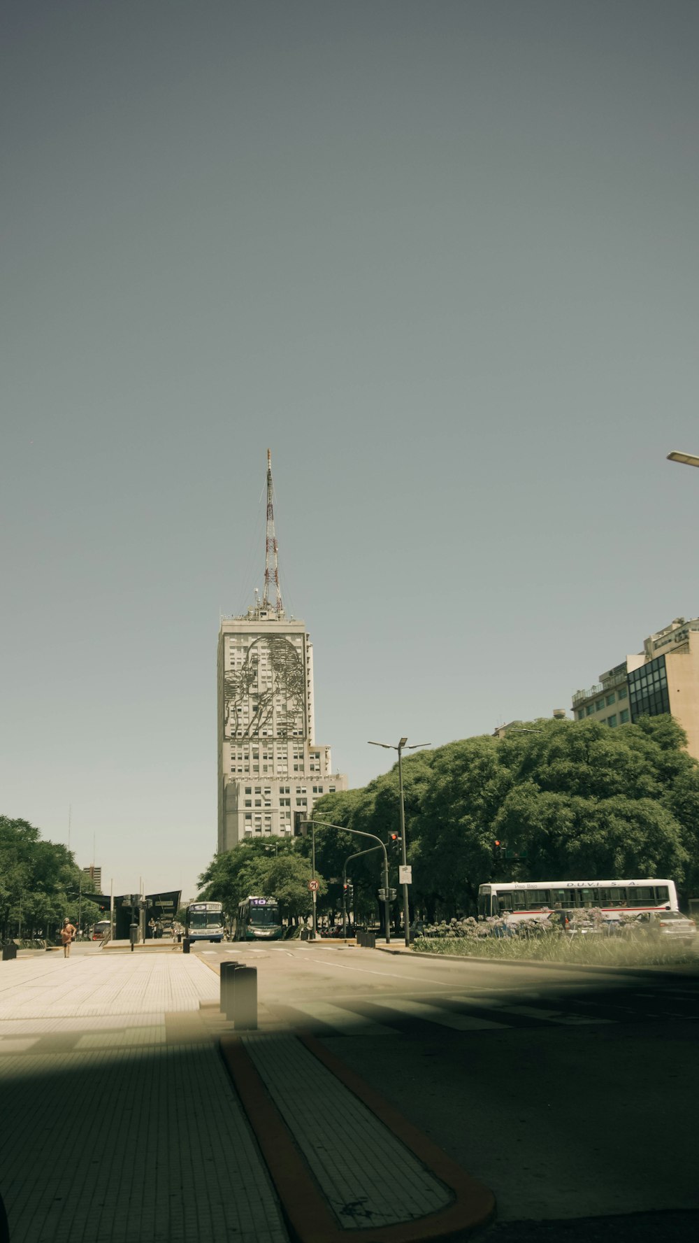 a city street with a tall building in the background