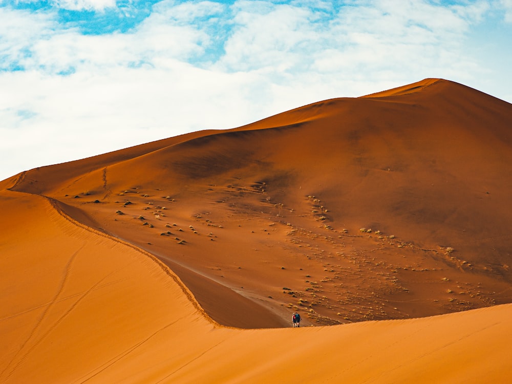 a large sand dune with a sky background