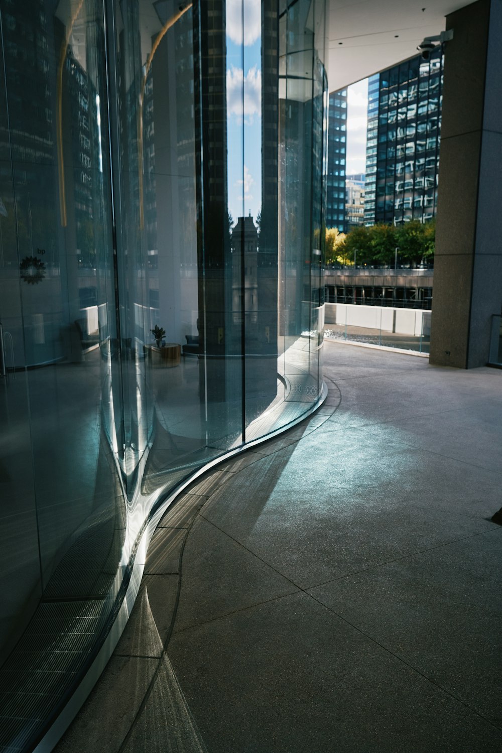 a curved glass wall in a large building