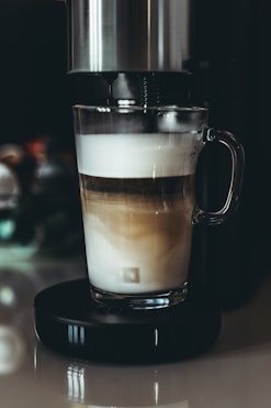 a cup of coffee sitting on top of a table